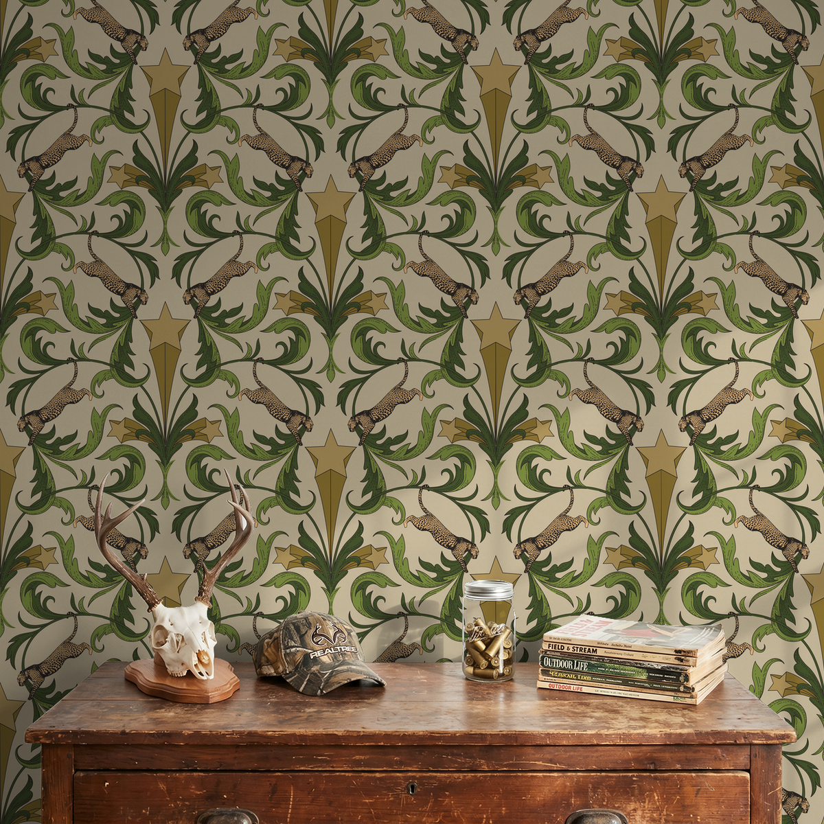 Hollywood Regency wallpaper with leopards, stars, and green leaves on blush background.