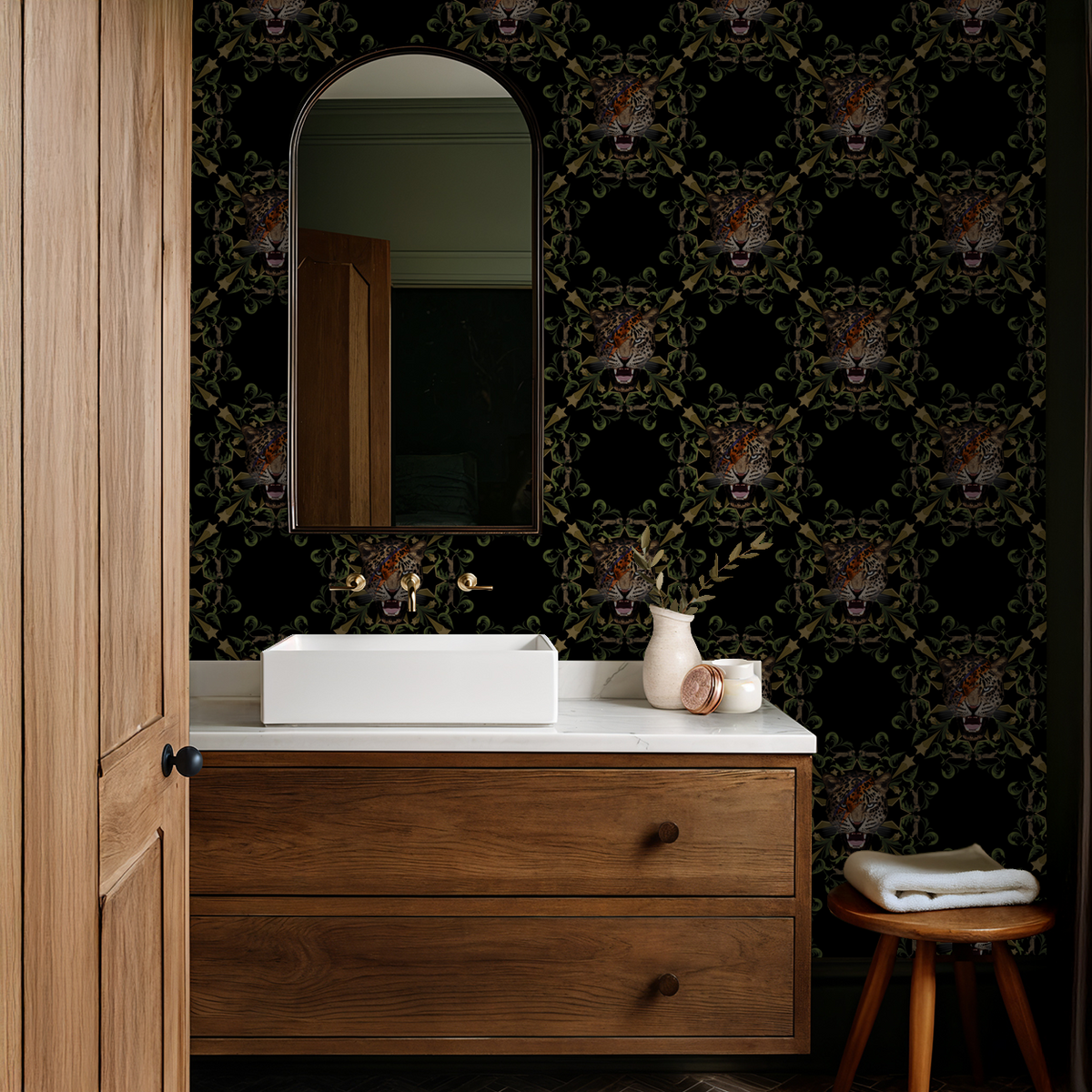 Bold leopard face wallpaper with foliage and star motifs in a modern bathroom setting.