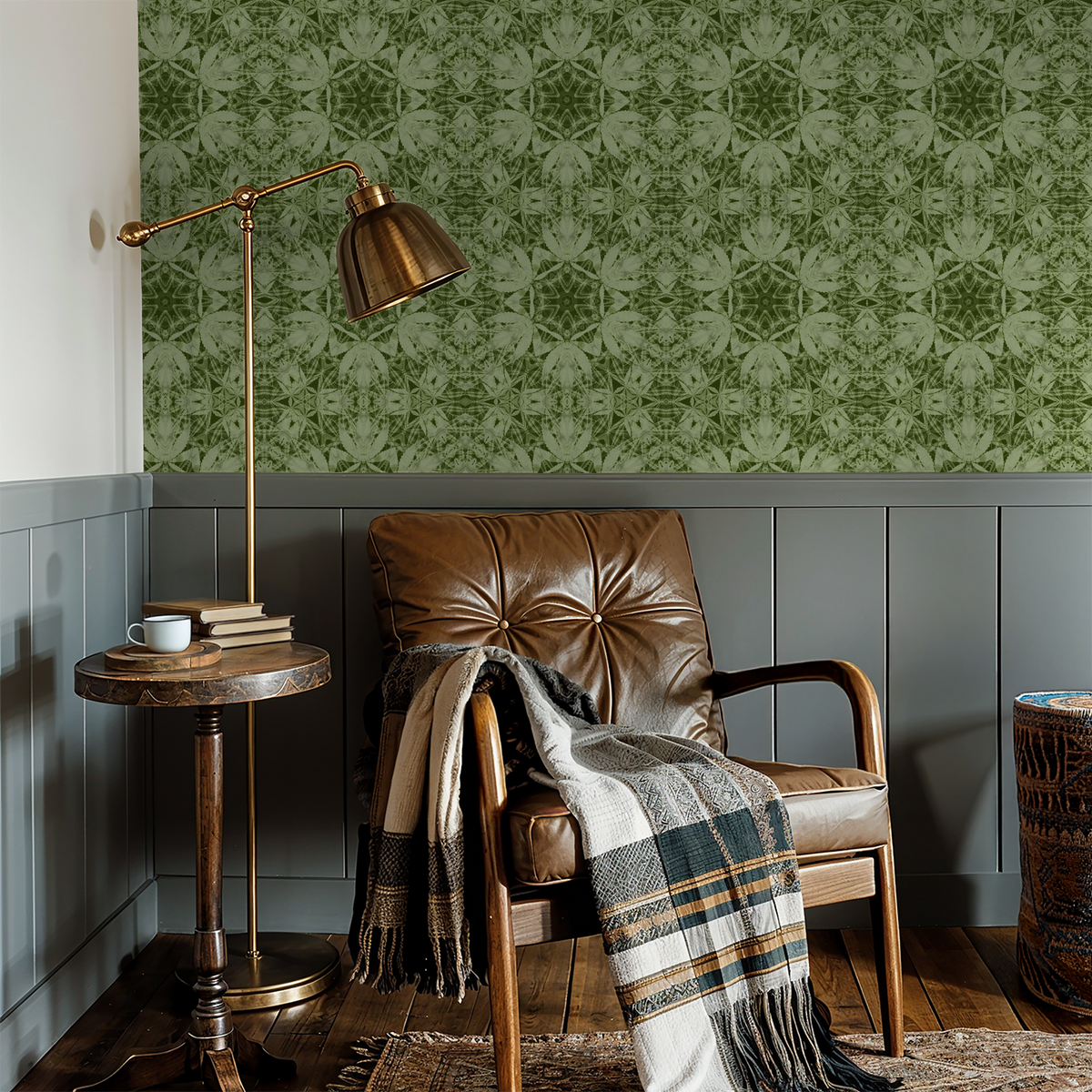 Olive green botanical wallpaper in cozy reading nook with leather chair.